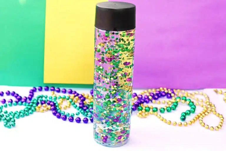 a mardi gras sensory bottle that uses mardi gras beads and glitter in water