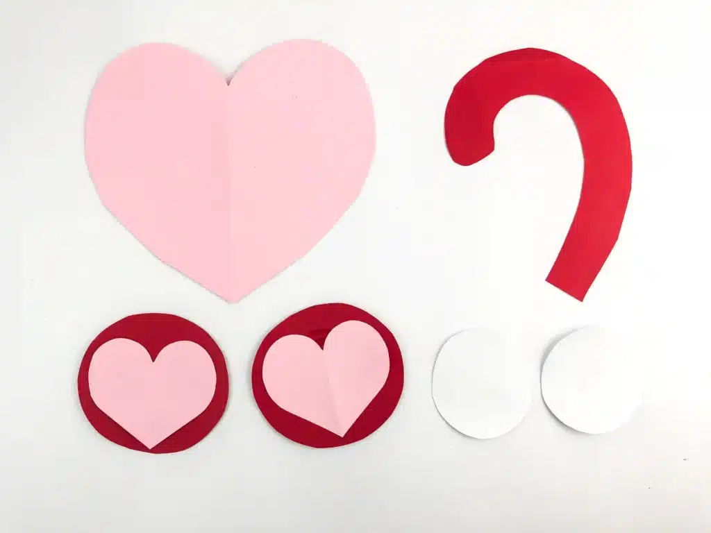 Valentine Monkey Craft - Cultivating Brilliant Minds pink red and white construction paper cut out into hearts and a monkey tail