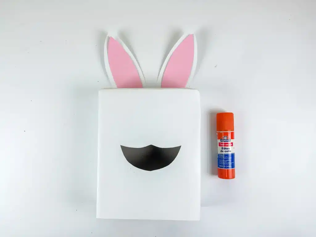 Bunny Valentines Box - Cultivating Brilliant Minds a box covered in white paper with construction paper bunny ears glued on top