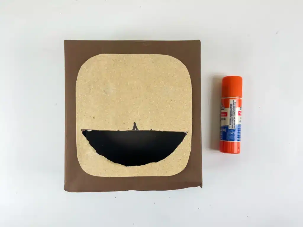 Sloth Valentine Box - Cultivating Brilliant Minds a box covered in brown paper with a tan piece of construction paper on top to outline the face