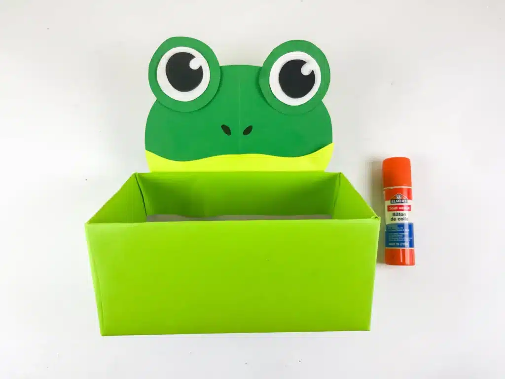 Frog Valentine Box - Cultivating Brilliant Minds a valentine box covered with green paper with a construction paper face