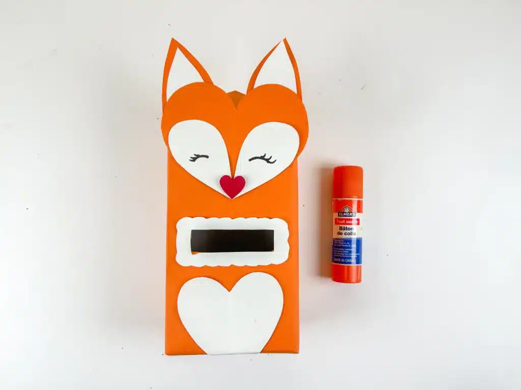 Fox Valentine Box - Cultivating Brilliant Minds a box covered with orange paper and a construction paper fox head glued on top