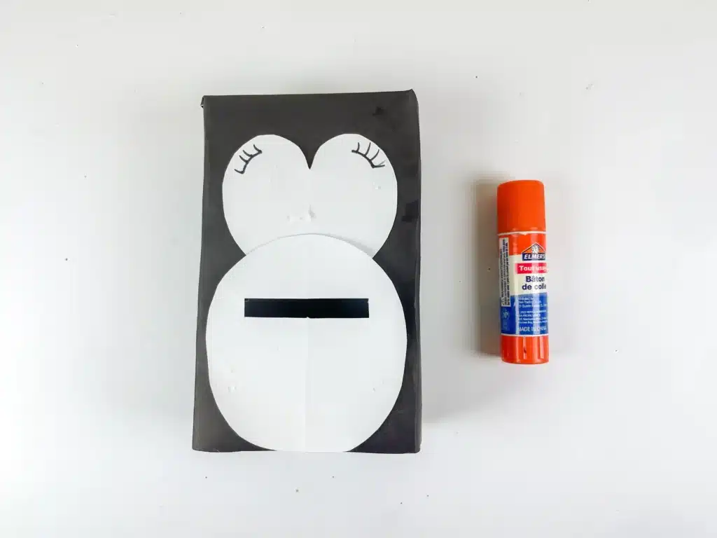 Penguin Valentine Box - Cultivating Brilliant Minds a box covered in black paper with white construction paper on top to look like the penguin's body