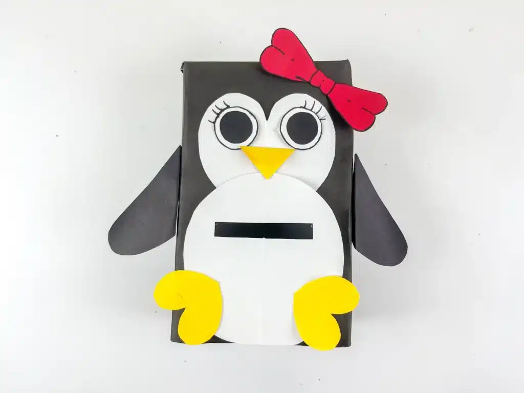 Penguin Valentine Box - Cultivating Brilliant Minds penguin valentines box - a box covered in black paper with a slide for valentines and decorated to look like a penguin
