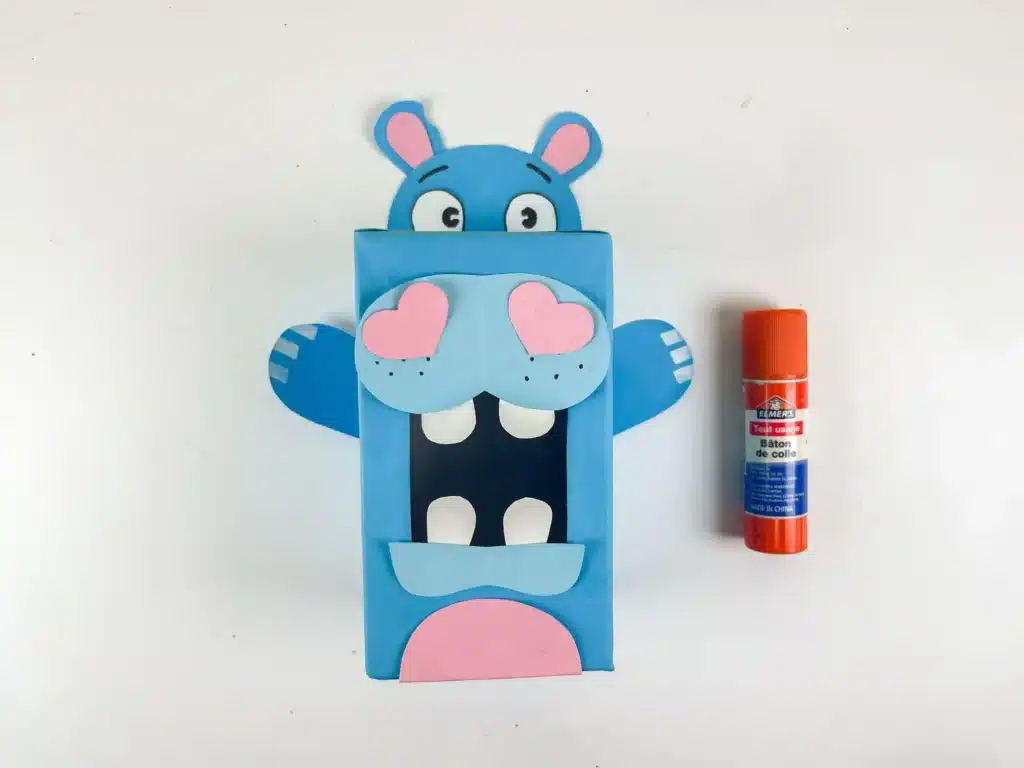 Hippo Valentine Box - Cultivating Brilliant Minds a hippo valentine box that is a box covered in blue paper with a construction paper face, snout. arms, and teeth