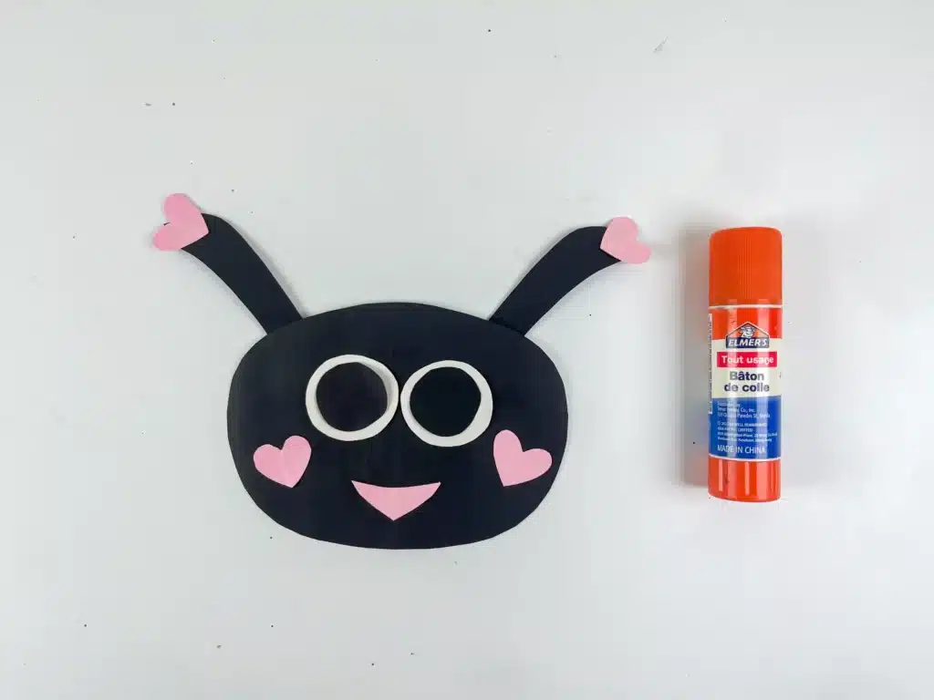 DIY Ladybug Valentine Box - Cultivating Brilliant Minds a ladybug face made from black, white, and pink construction paper