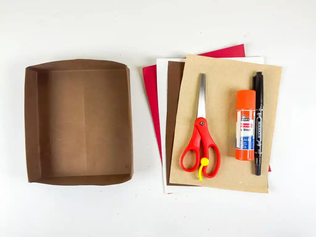 Bear Valentines Box - Cultivating Brilliant Minds a box covered in brown paper, colored construction paper, scissors, glue, and a black marker