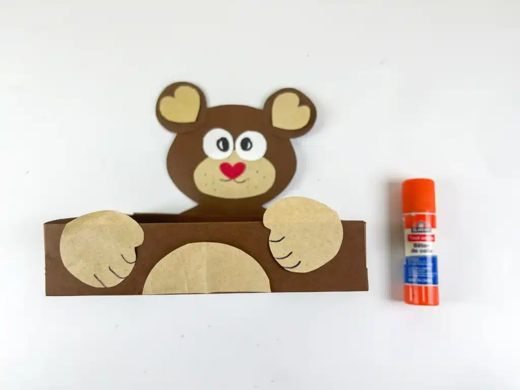 Bear Valentines Box - Cultivating Brilliant Minds a bear valentines box that has a box wrapped in brown paper and a bear head and arms made out of construction paper