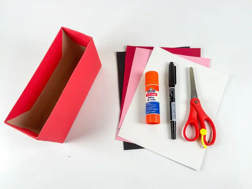 Love Bear Valentine Box - Cultivating Brilliant Minds a cardboard box covered in red paper, colored construction paper, scissors, glue, and a black marker
