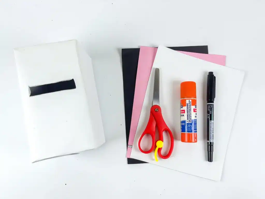 Panda Valentines Box - Cultivating Brilliant Minds a box covered in white paper, colored construction paper, scissors, glue, and a black marker