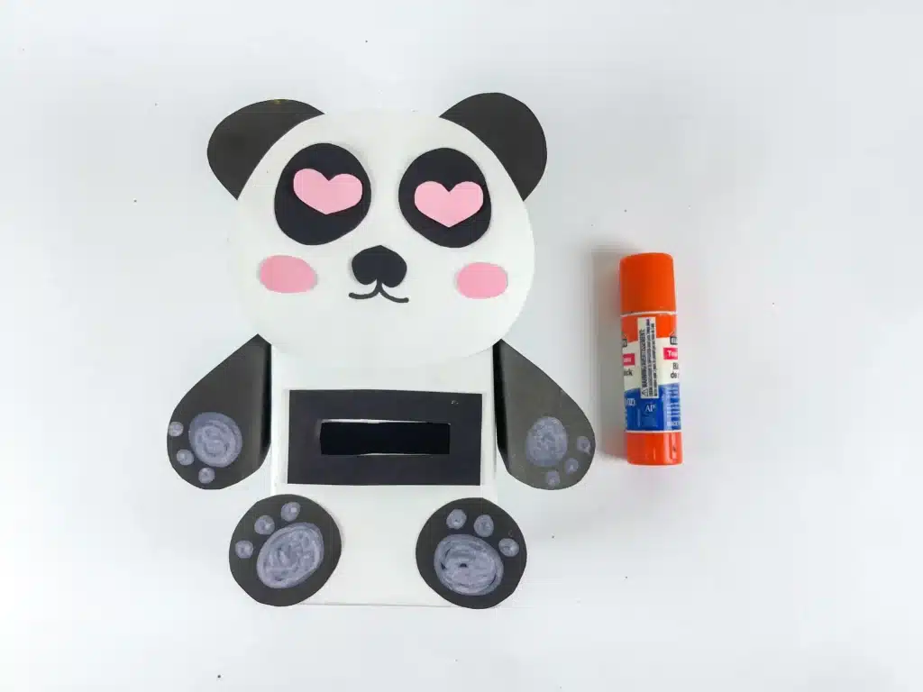 Panda Valentines Box - Cultivating Brilliant Minds a panda valentines box that has a box wrapped in white paper and a construction paper panda face, arms, and legs attached