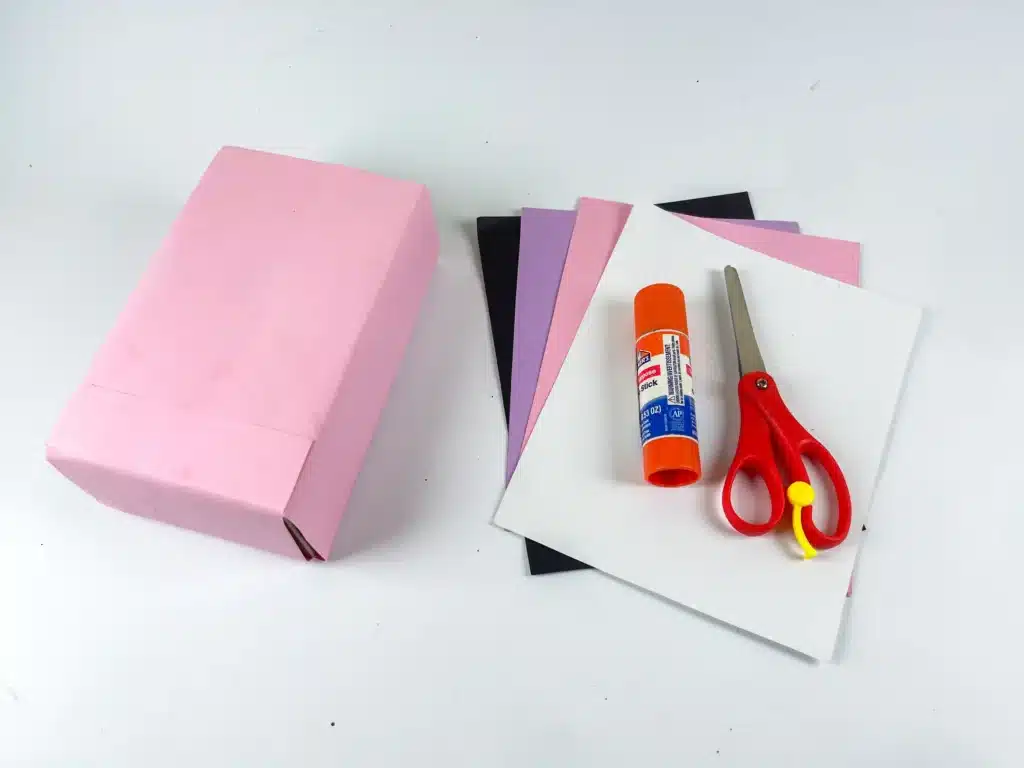 Butterfly Valentines Box - Cultivating Brilliant Minds a box wrapped in pink paper, colored construction paper, glue, and scissors