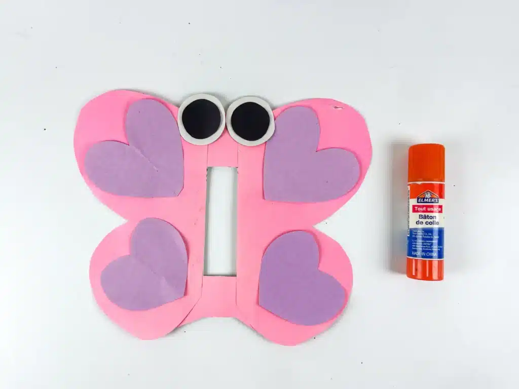 Butterfly Valentines Box - Cultivating Brilliant Minds butterfly wings cut out of pink paper with purple hearts glued on the wings and eyes at the top