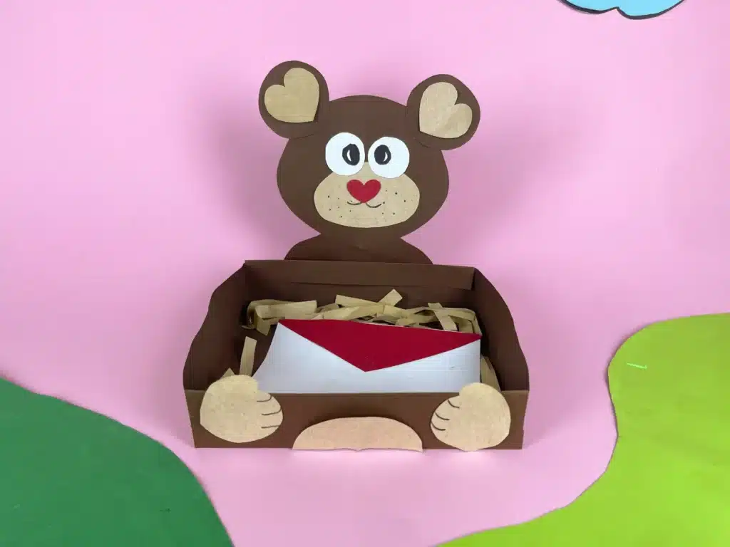 Bear Valentines Box - Cultivating Brilliant Minds a bear valentines box that has a box wrapped in brown paper and a bear head and arms made out of construction paper