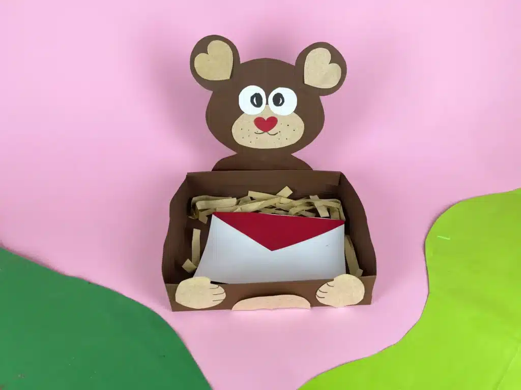 Bear Valentines Box - Cultivating Brilliant Minds a bear valentines box that has a box wrapped in brown paper and a bear head and arms made out of construction paper
