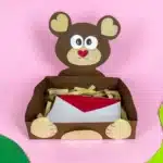 Bear Valentines Box - Cultivating Brilliant Minds a bear valentines box that has a box wrapped in brown paper and a bear head and arms made out of construction paper