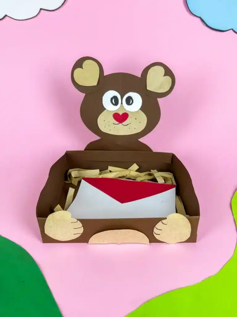 Bear Valentines Box - Cultivating Brilliant Minds a bear valentines box that has a box wrapped in brown paper and a bear head and arms made out of construction paper