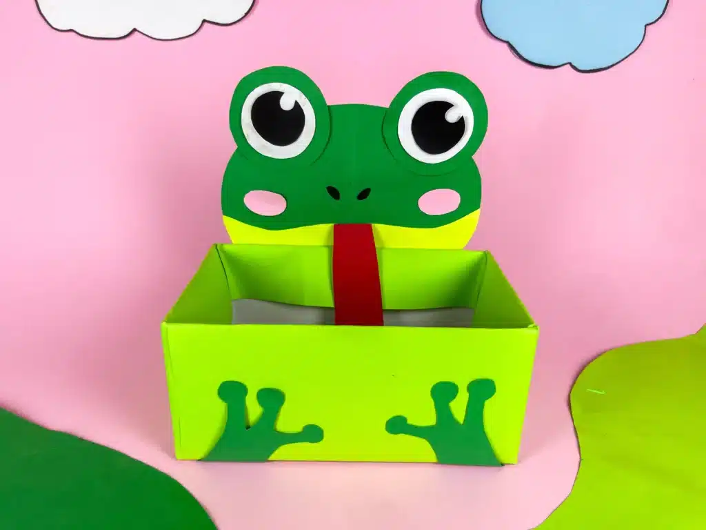 Frog Valentine Box - Cultivating Brilliant Minds a valentine box covered with green paper with a construction paper face and legs
