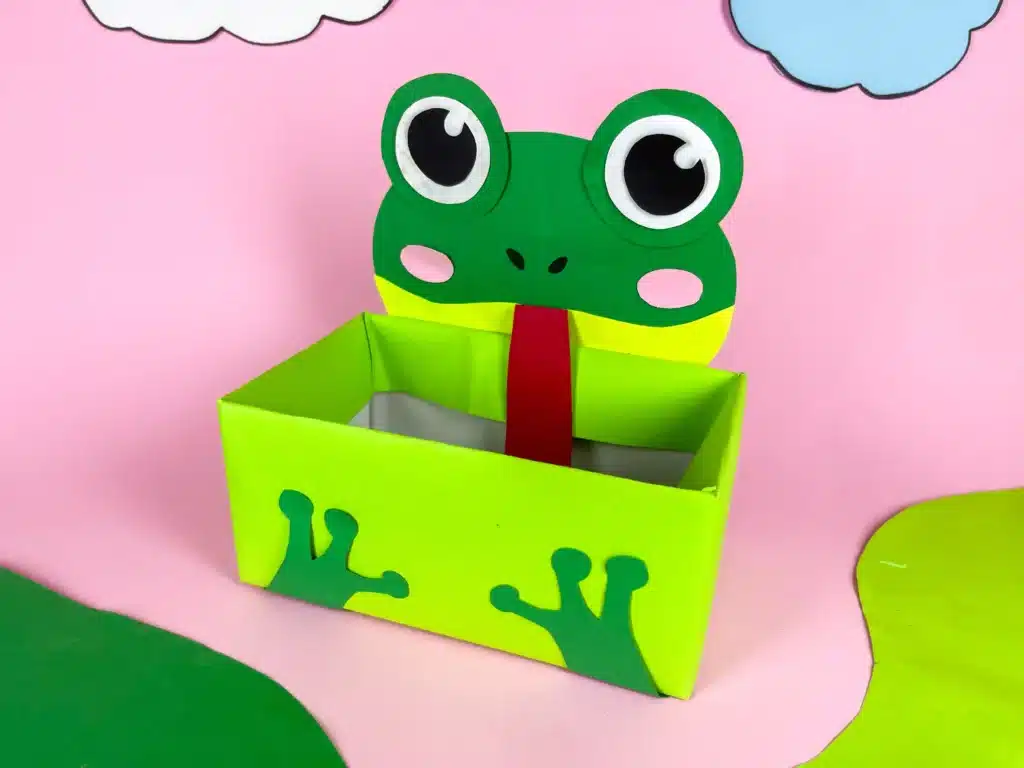 Frog Valentine Box - Cultivating Brilliant Minds a valentine box covered with green paper with a construction paper face and legs