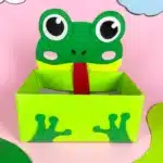 Frog Valentine Box - Cultivating Brilliant Minds a valentine box covered with green paper with a construction paper face and legs