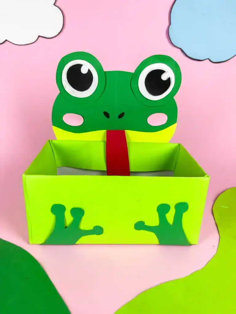 Frog Valentine Box - Cultivating Brilliant Minds a valentine box covered with green paper with a construction paper face and legs