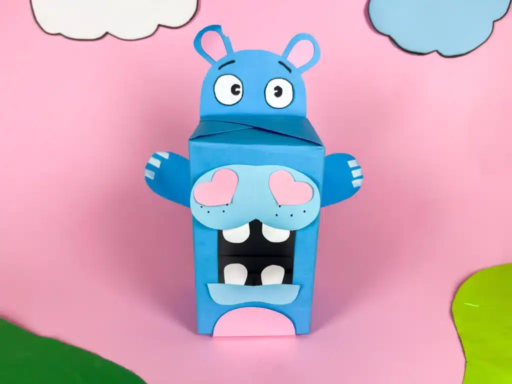 Hippo Valentine Box - Cultivating Brilliant Minds a hippo valentine box that is a box covered in blue paper with a construction paper face, snout. arms, and teeth