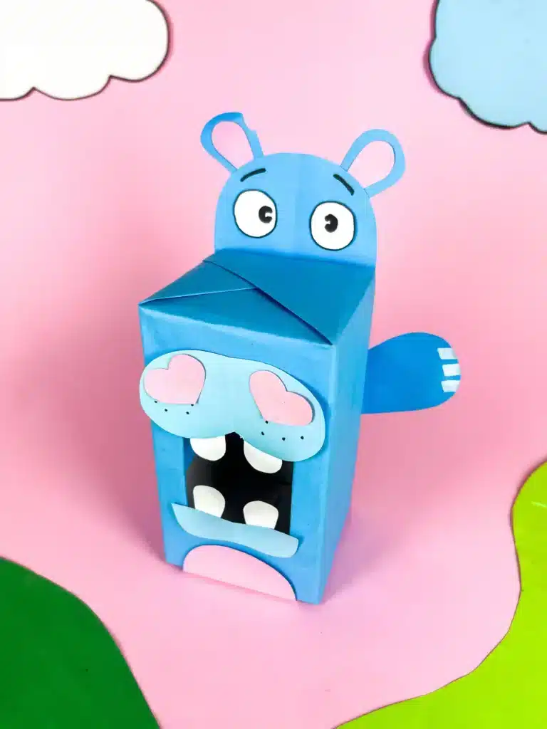 Hippo Valentine Box - Cultivating Brilliant Minds a hippo valentine box that is a box covered in blue paper with a construction paper face, snout. arms, and teeth