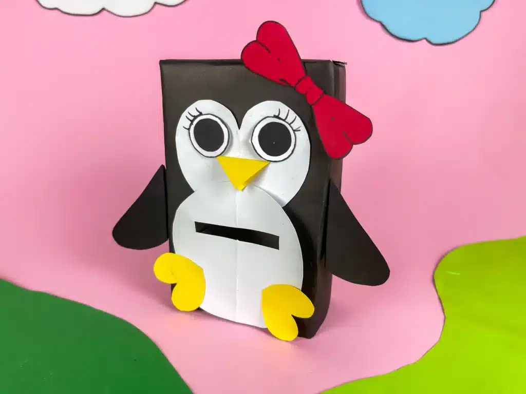 Penguin Valentine Box - Cultivating Brilliant Minds penguin valentines box - a box covered in black paper with a slide for valentines and decorated to look like a penguin