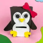 Penguin Valentine Box - Cultivating Brilliant Minds penguin valentines box - a box covered in black paper with a slide for valentines and decorated to look like a penguin