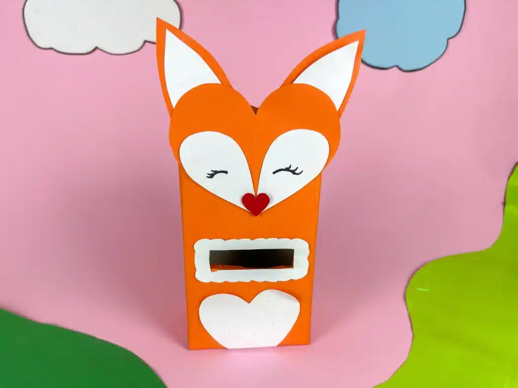 Fox Valentine Box - Cultivating Brilliant Minds a box covered with orange paper and a construction paper fox head glued on top