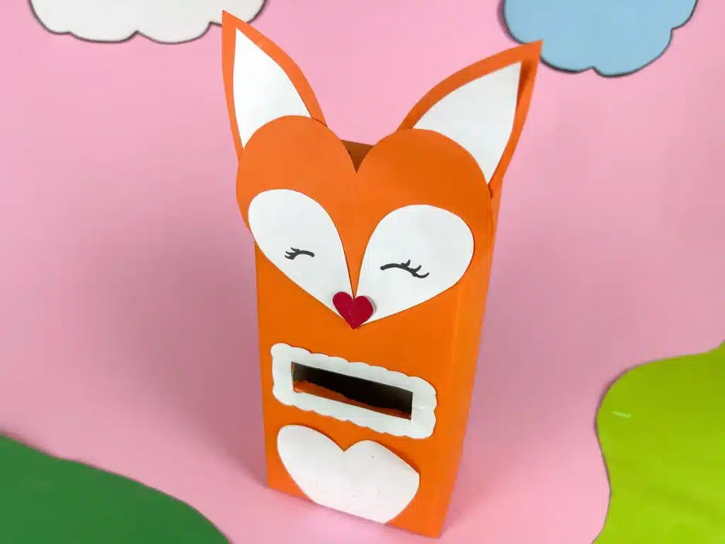 Fox Valentine Box - Cultivating Brilliant Minds a box covered with orange paper and a construction paper fox head glued on top