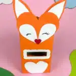 Fox Valentine Box - Cultivating Brilliant Minds a box covered with orange paper and a construction paper fox head glued on top