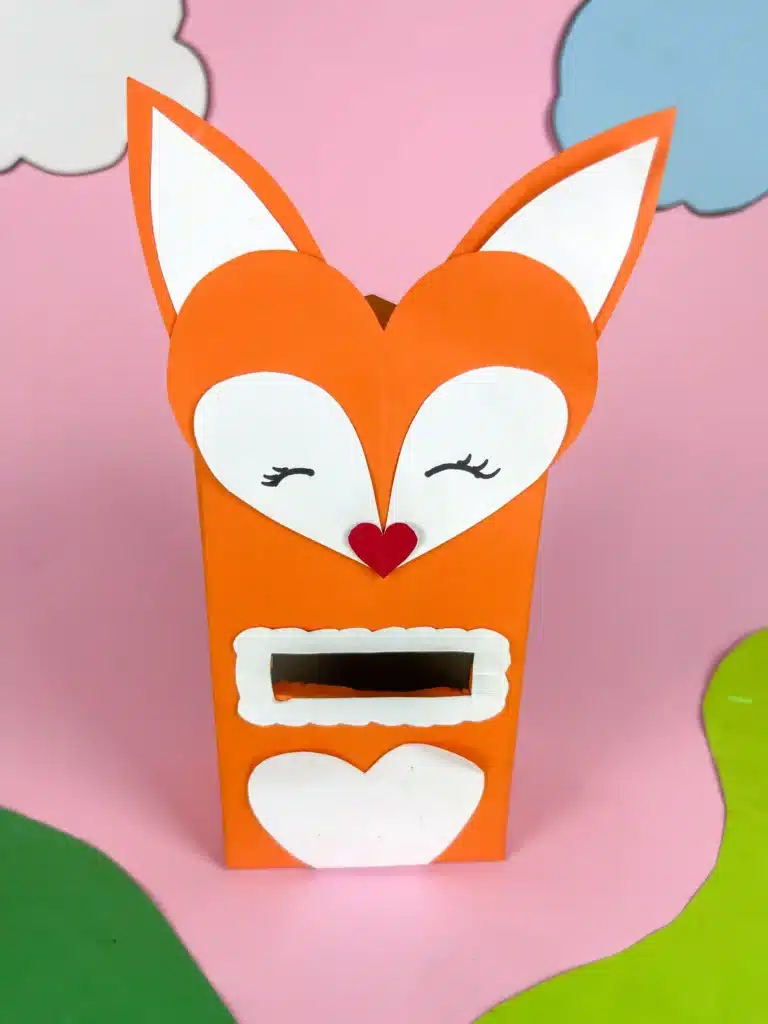 Fox Valentine Box - Cultivating Brilliant Minds a box covered with orange paper and a construction paper fox head glued on top