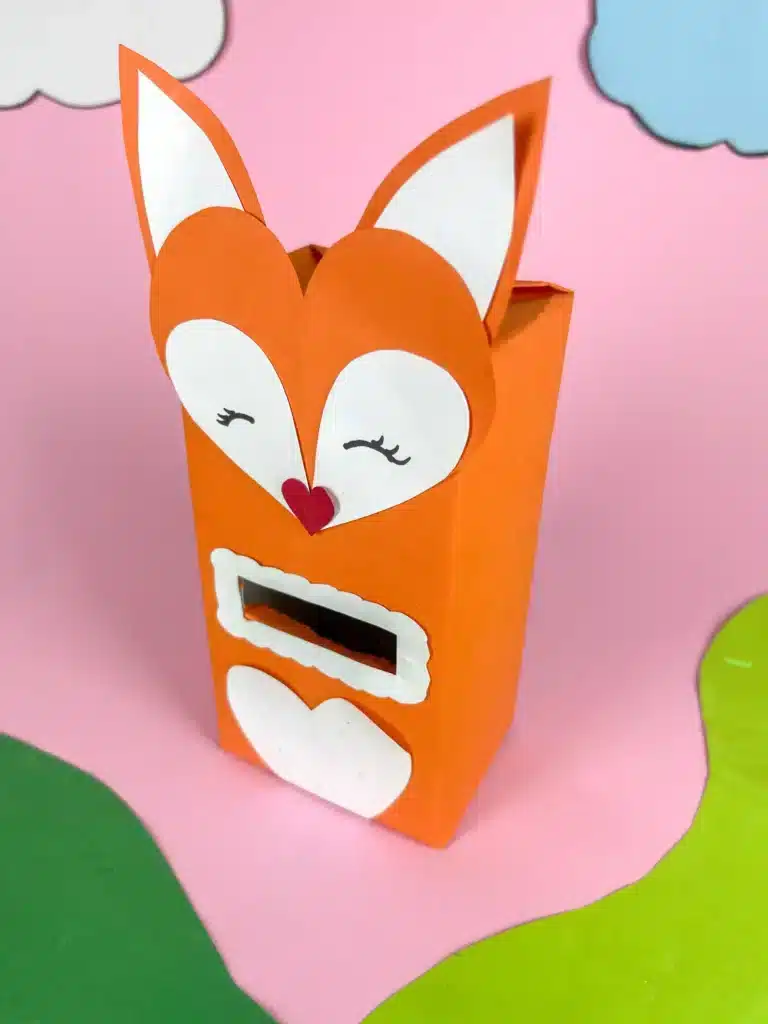 Fox Valentine Box - Cultivating Brilliant Minds a box covered with orange paper and a construction paper fox head glued on top