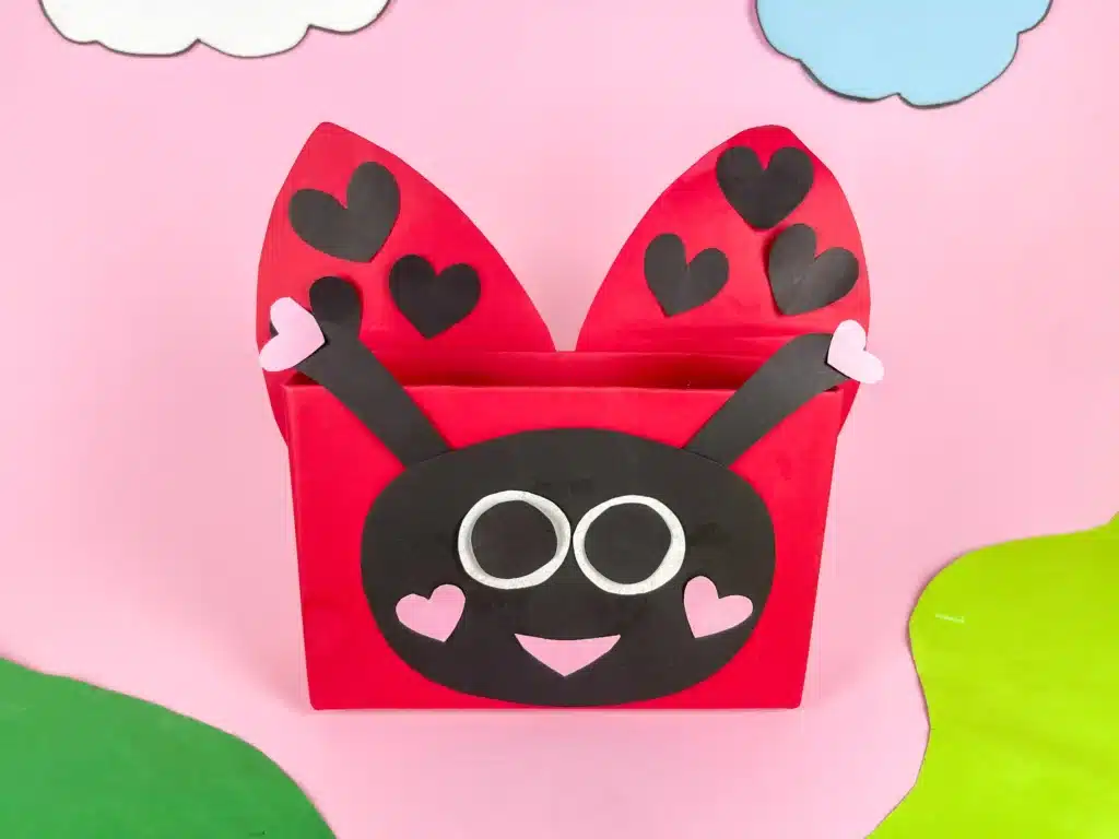 DIY Ladybug Valentine Box - Cultivating Brilliant Minds a diy valentine box that is covered in red paper and decorated with construction paper to look like a ladybug