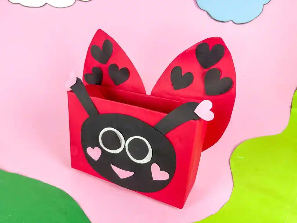 DIY Ladybug Valentine Box - Cultivating Brilliant Minds a diy ladybug valentine box that is covered in red paper and decorated with construction paper to look like a ladybug