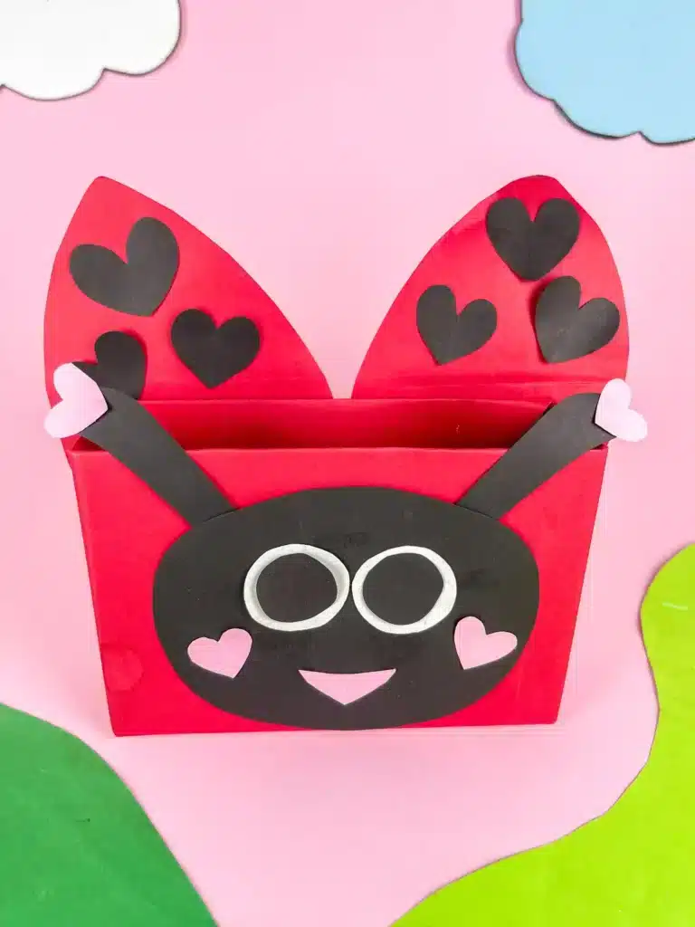 DIY Ladybug Valentine Box - Cultivating Brilliant Minds a diy valentine box that is covered in red paper and decorated with construction paper to look like a ladybug