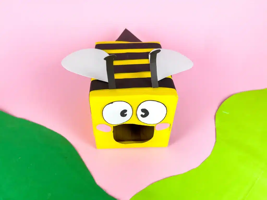Bee Valentines Box - Cultivating Brilliant Minds bee valentines box that has a box wrapped in yellow paper with black stripes and a construction paper face, wings, and antennae
