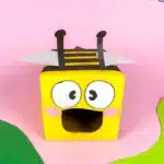 Bee Valentines Box - Cultivating Brilliant Minds bee valentines box that has a box wrapped in yellow paper with black stripes and a construction paper face, wings, and antennae