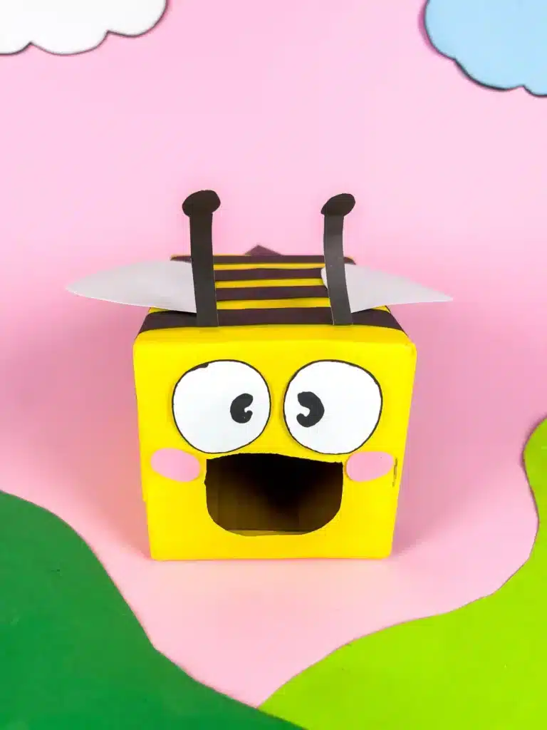 Bee Valentines Box - Cultivating Brilliant Minds bee valentines box that has a box wrapped in yellow paper with black stripes and a construction paper face, wings, and antennae