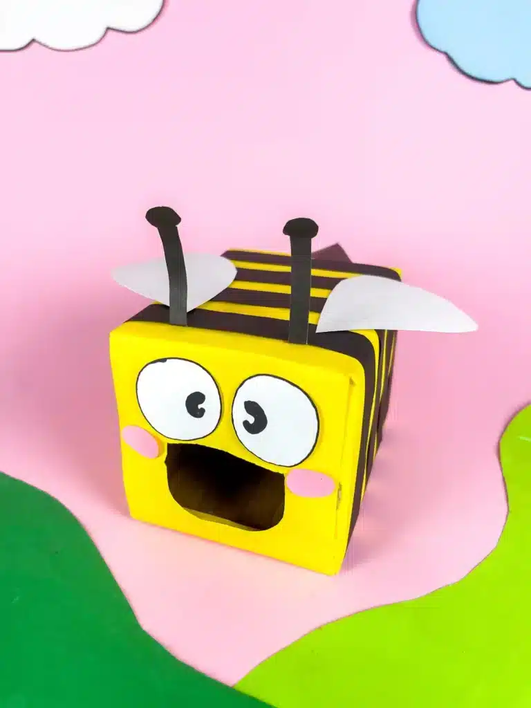 Bee Valentines Box - Cultivating Brilliant Minds bee valentines box that has a box wrapped in yellow paper with black stripes and a construction paper face, wings, and antennae