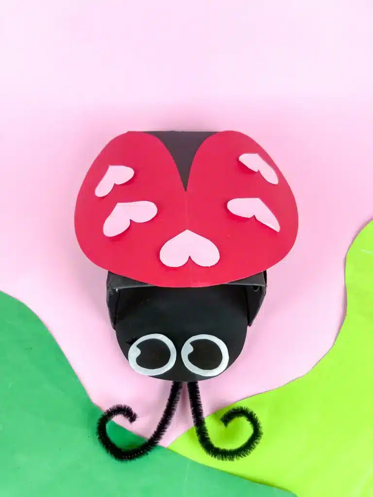 Ladybug Valentines Box - Cultivating Brilliant Minds a ladybug valentines box that has a box covered in black paper with a construction paper ladybug head and construction paper wings with hearts