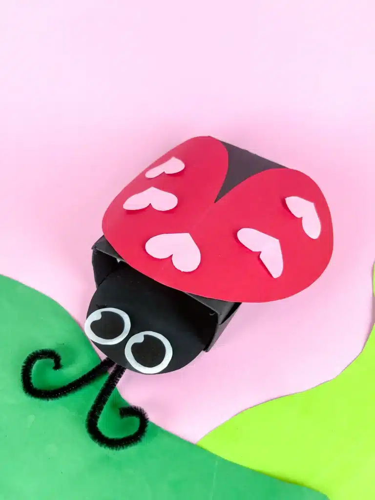 Ladybug Valentines Box - Cultivating Brilliant Minds a ladybug valentines box that has a box covered in black paper with a construction paper ladybug head and construction paper wings with hearts