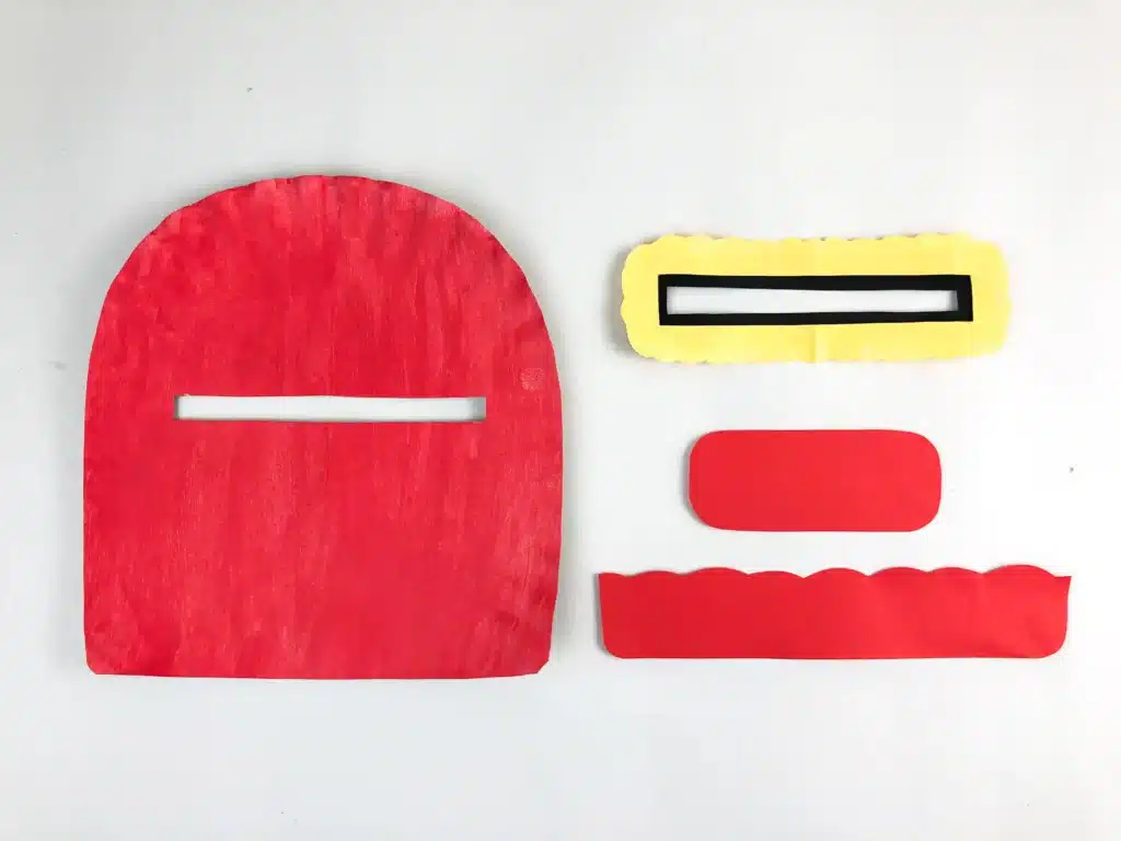 Valentine's Day Mailbox Paper Plate Craft - Cultivating Brilliant Minds a paper plate painted a pink-red color and cut into the shape of a mailbox with a slot cut out for mail and a scalloped strip cut out of red paper