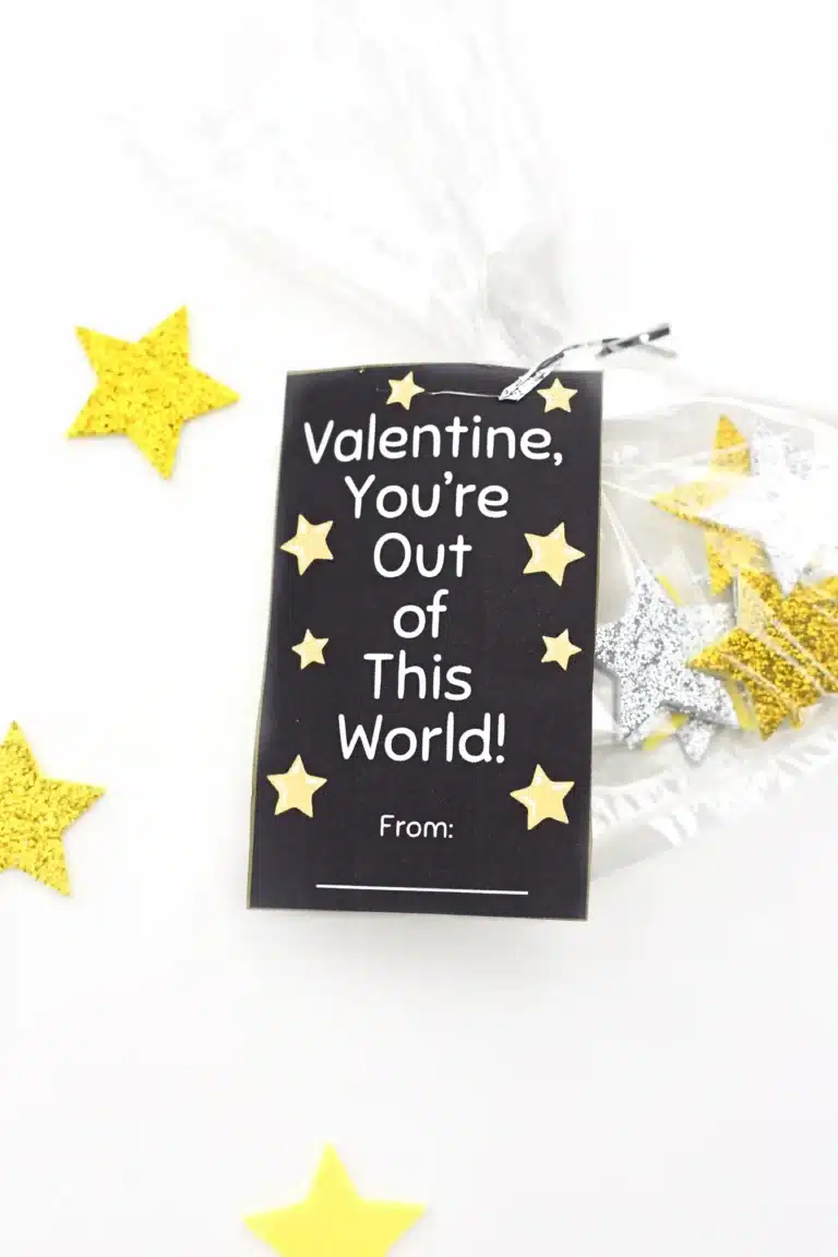 Printable valentines that read "valentine, you're out of this world" attached to a bag of foam stars