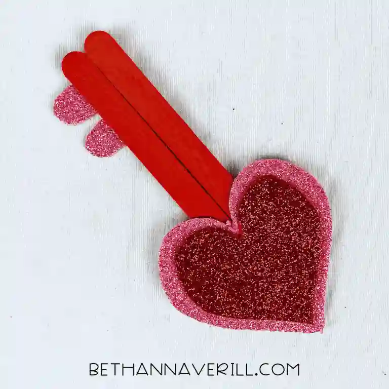 Heart-Themed Crafts For Kids This Valentine's Day - Cultivating Brilliant Minds a heart shaped key made out of popsicle sticks and construction paper