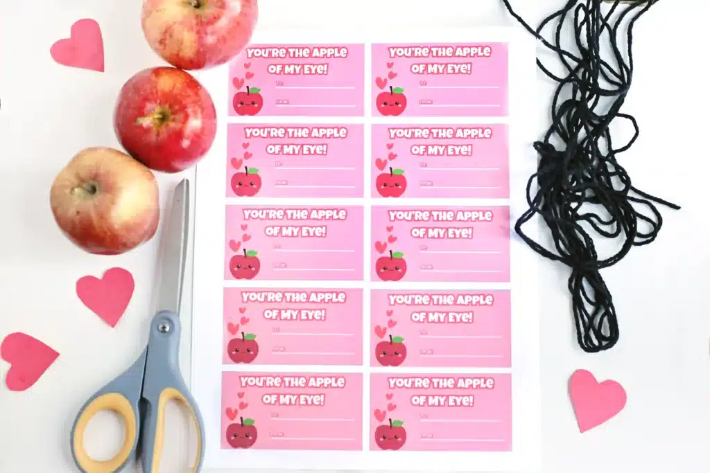Printable Valentines: You're the Apple of My Eye - Cultivating Brilliant Minds printable valentine with an apple on it that says "you're the apple of my eye", an apple, scissors, and string