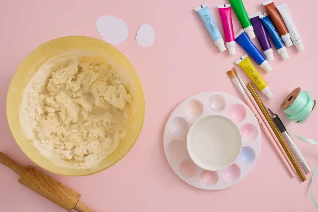 Easter Egg Salt Dough Ornaments - Cultivating Brilliant Minds salt dough mixture in a bowl next to a paint palette