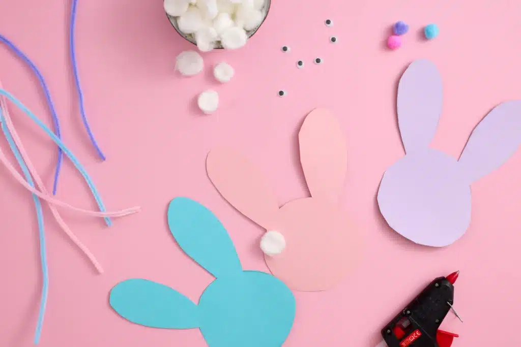 Cotton Ball Bunny Craft - Cultivating Brilliant Minds a bunny silhouette cut out of construction paper with a cotton ball glued on