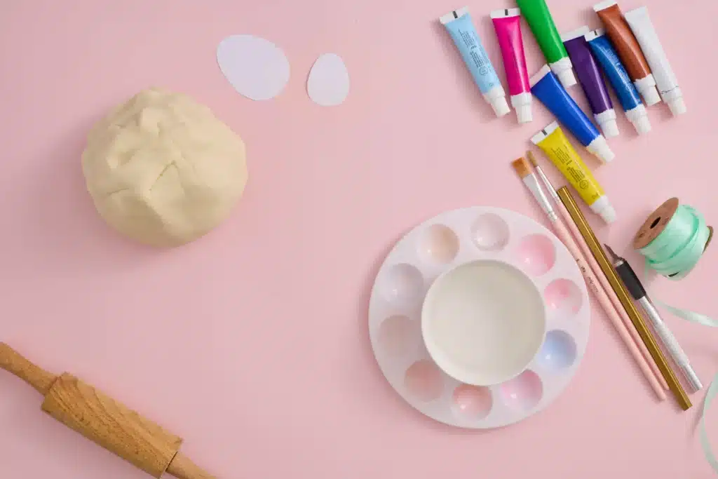Easter Egg Salt Dough Ornaments - Cultivating Brilliant Minds salt dough rolled into a ball next to a rolling pin and paint palette